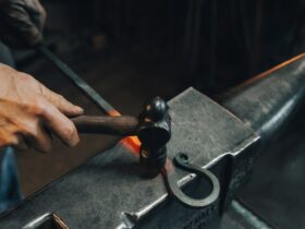 person holding black metal pipe