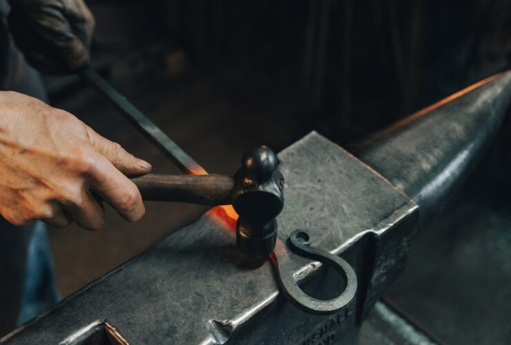 person holding black metal pipe