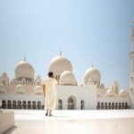 man standing near white mosque
