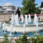 fountain in front of brown building