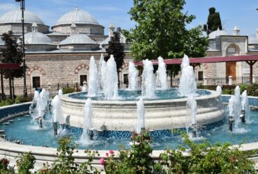 fountain in front of brown building