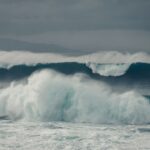 ocean waves crashing on shore during daytime