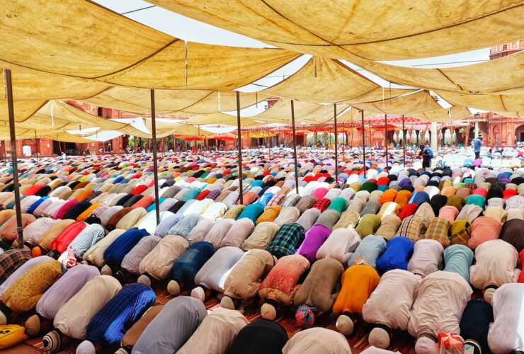 people bowing down inside canopy during day