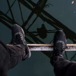 person standing on brown metal bar