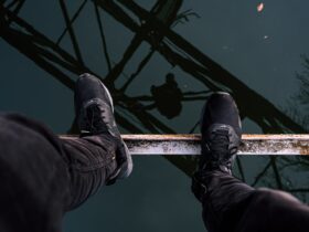 person standing on brown metal bar