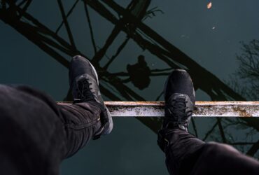 person standing on brown metal bar
