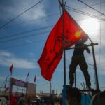 man holding red flag