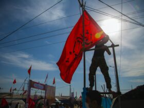 man holding red flag