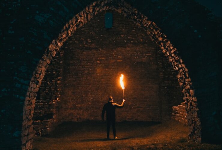 person holding torch in building interior