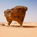 brown rock formation on brown sand during daytime