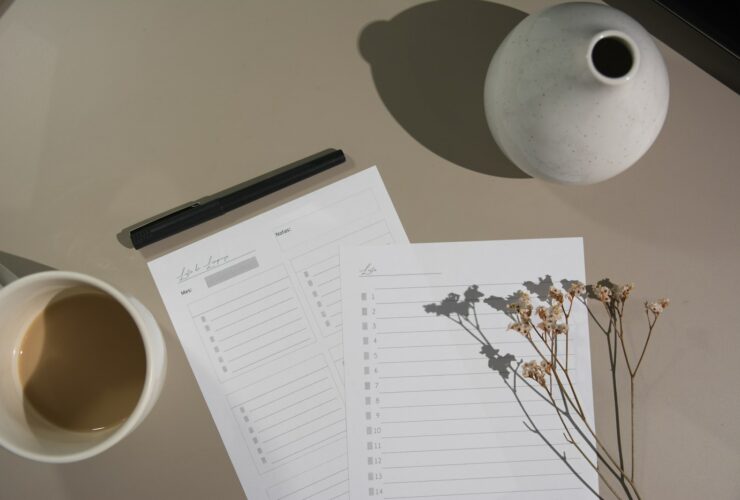 white printer paper beside white ceramic mug
