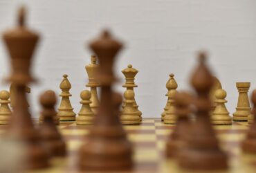 brown chess piece on white surface