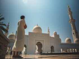 man standing near white mosque