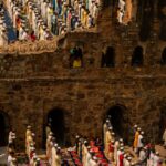 people in traditional dress standing on brown concrete building during daytime