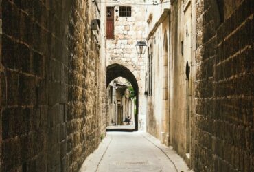 person walking on gray concrete pathway during daytime