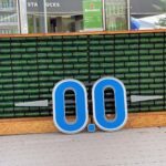 blue and white signage on brown brick wall
