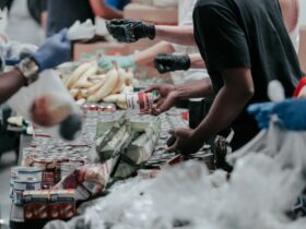 man in black t-shirt holding coca cola bottle