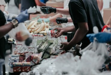 man in black t-shirt holding coca cola bottle
