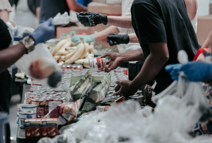 man in black t-shirt holding coca cola bottle