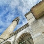 low angle photography of beige concrete building under blue sky during daytime
