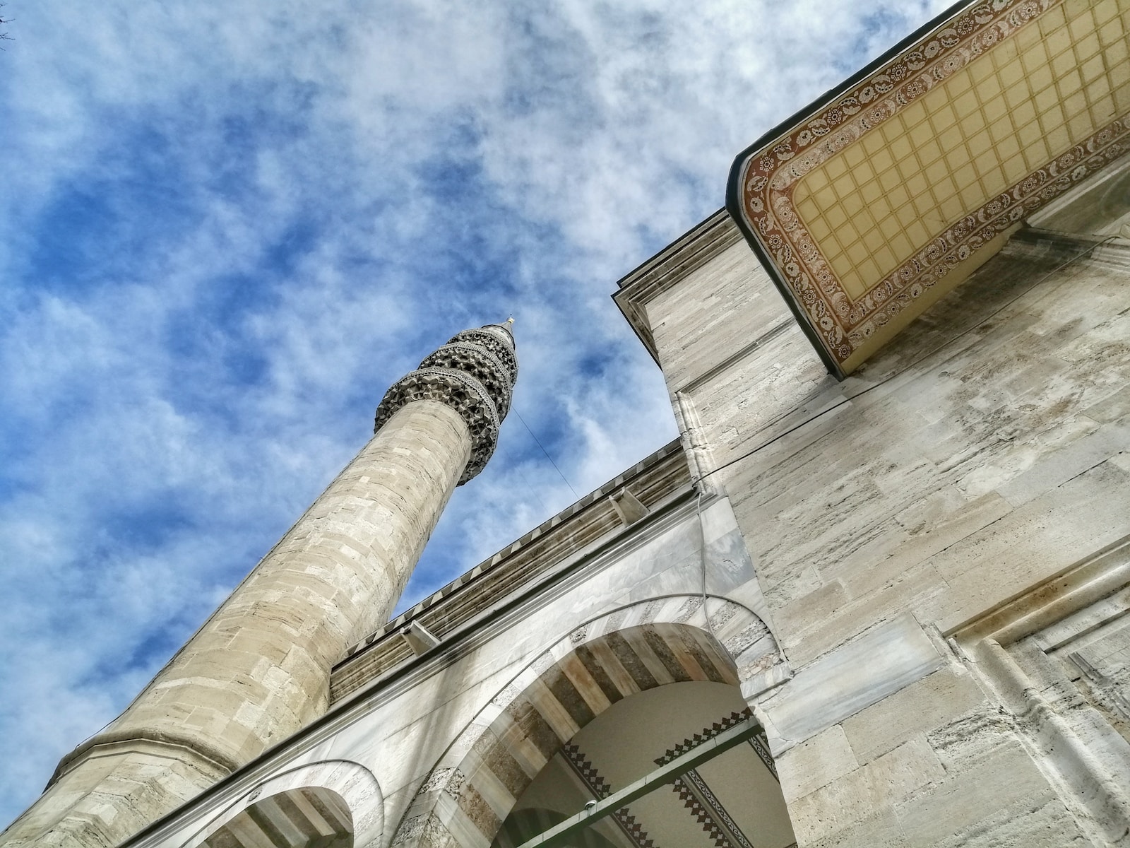 low angle photography of beige concrete building under blue sky during daytime