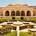 a large building with a fountain in the middle of it