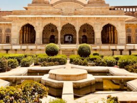 a large building with a fountain in the middle of it