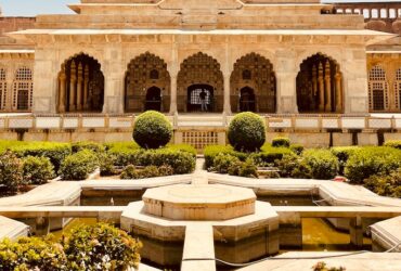 a large building with a fountain in the middle of it