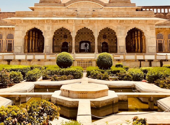 a large building with a fountain in the middle of it