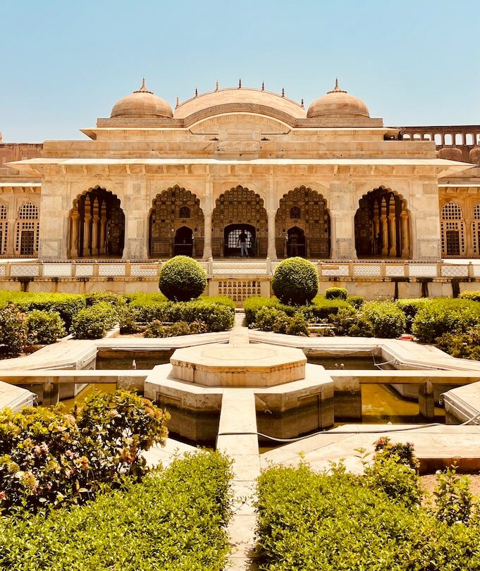 a large building with a fountain in the middle of it