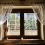 white floral window curtain on white wooden framed glass window