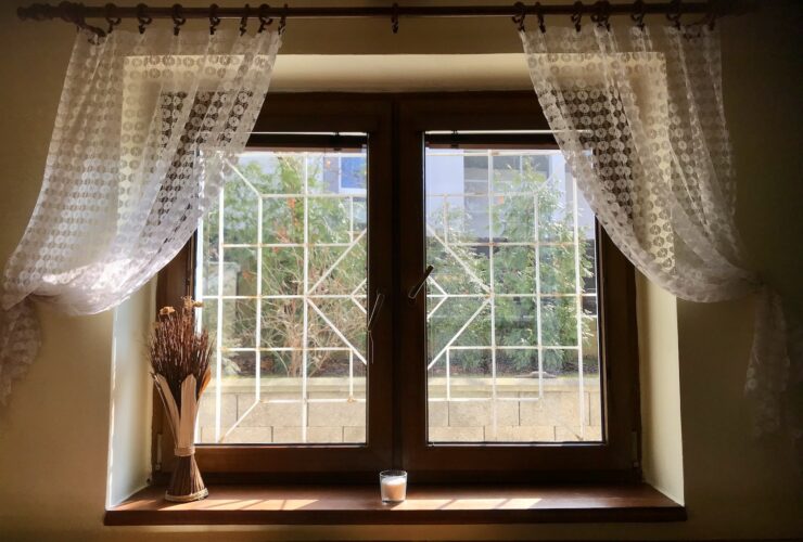 white floral window curtain on white wooden framed glass window