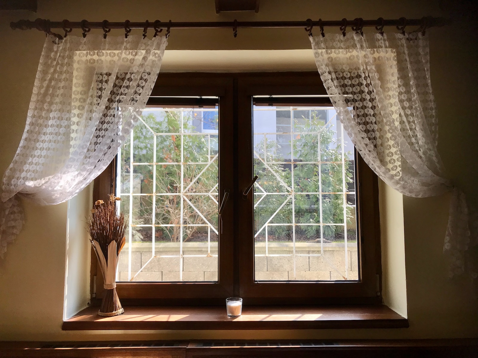 white floral window curtain on white wooden framed glass window