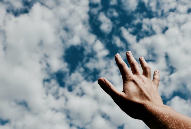 person hand reaching for the sky