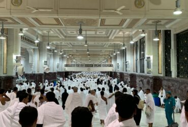 a group of people in white robes