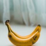 yellow banana fruit on white textile