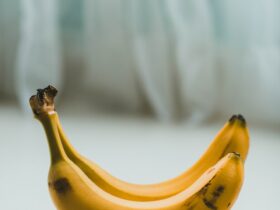 yellow banana fruit on white textile