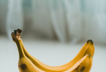 yellow banana fruit on white textile