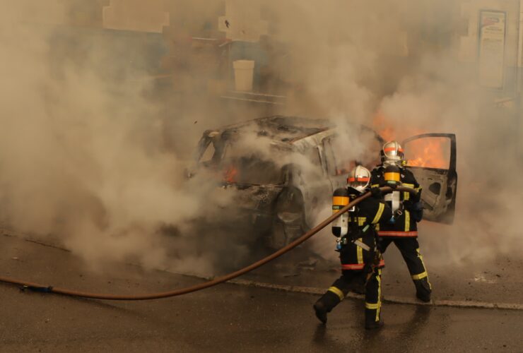 man in yellow and red suit holding black and yellow hose