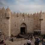 a group of people standing in front of a castle