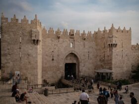 a group of people standing in front of a castle