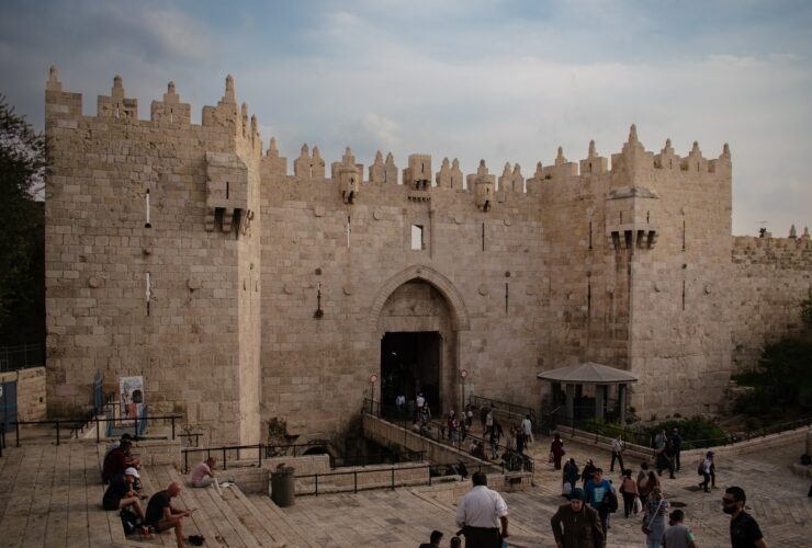 a group of people standing in front of a castle