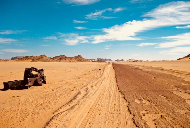 black suv on brown sand under blue sky during daytime