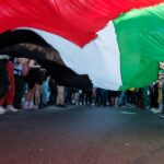 a group of people standing on the side of a road