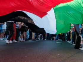 a group of people standing on the side of a road
