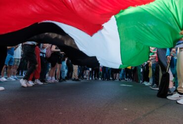 a group of people standing on the side of a road