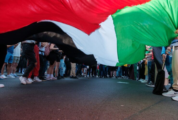 a group of people standing on the side of a road
