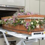 a wicker basket with flowers in it on a conveyor belt