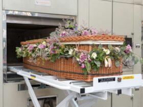 a wicker basket with flowers in it on a conveyor belt