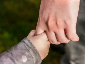 Child Holding Hand of Another Person